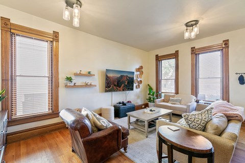 a living room with a couch and chairs and a table